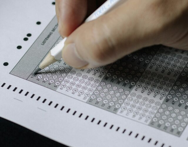 person writing on white paper