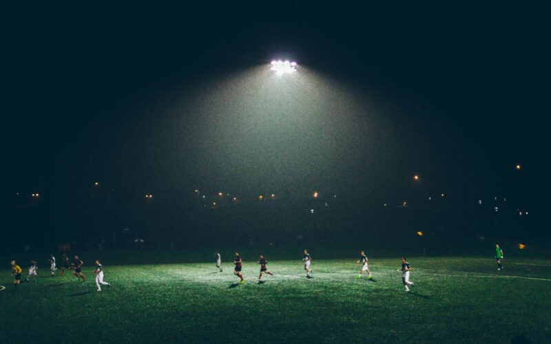group of people playing soccer on soccer field