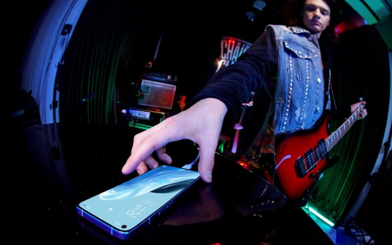 a person holding a cell phone in their hand