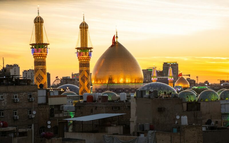 A sunset view of a city with tall buildings