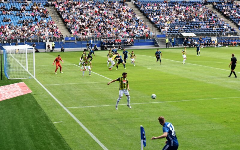 men playing soccer of soccer field during daytime