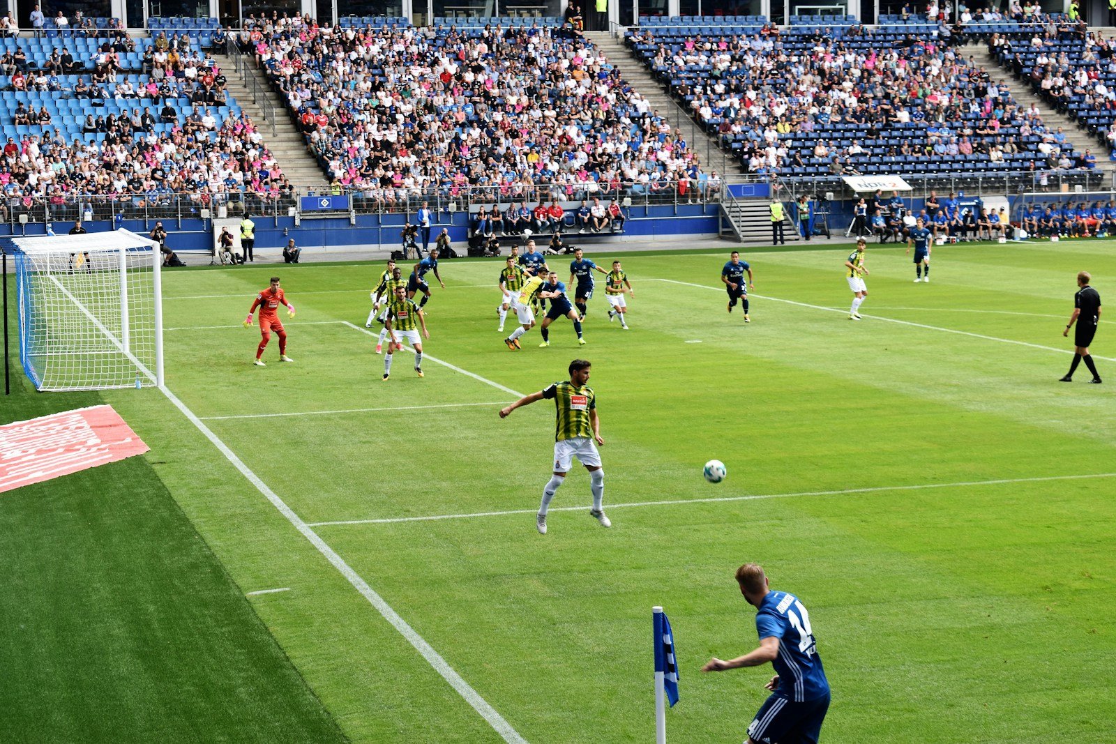 men playing soccer of soccer field during daytime