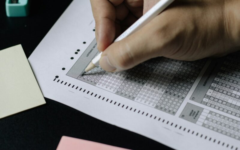 person writing on white paper