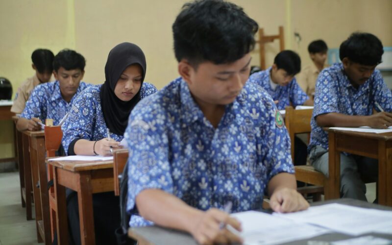 Students are taking a test in a classroom.
