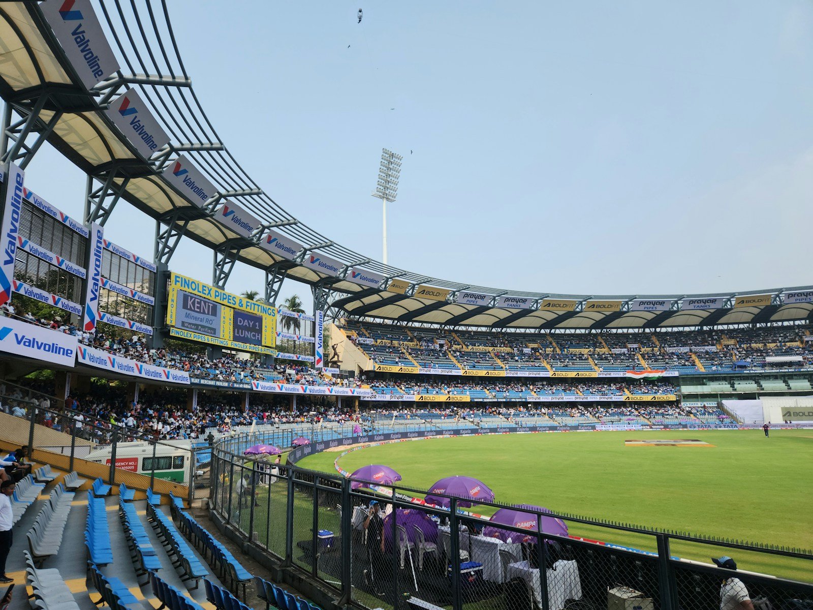 A cricket stadium filled with lots of people