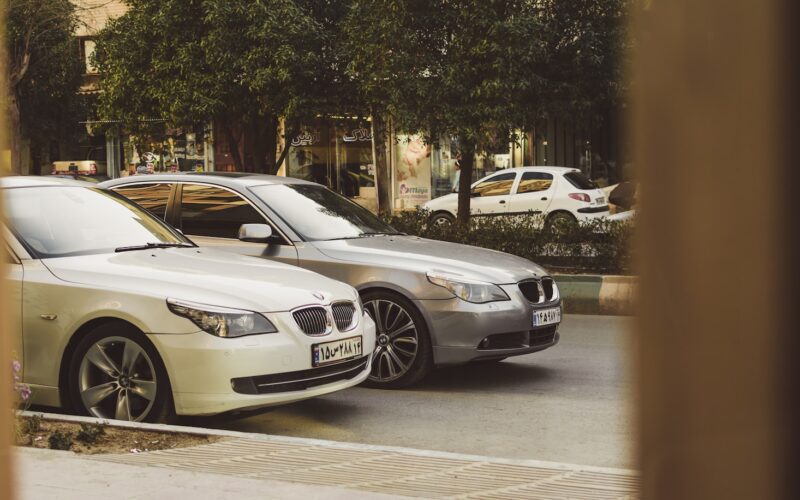 white BMW vehicle on gray top road