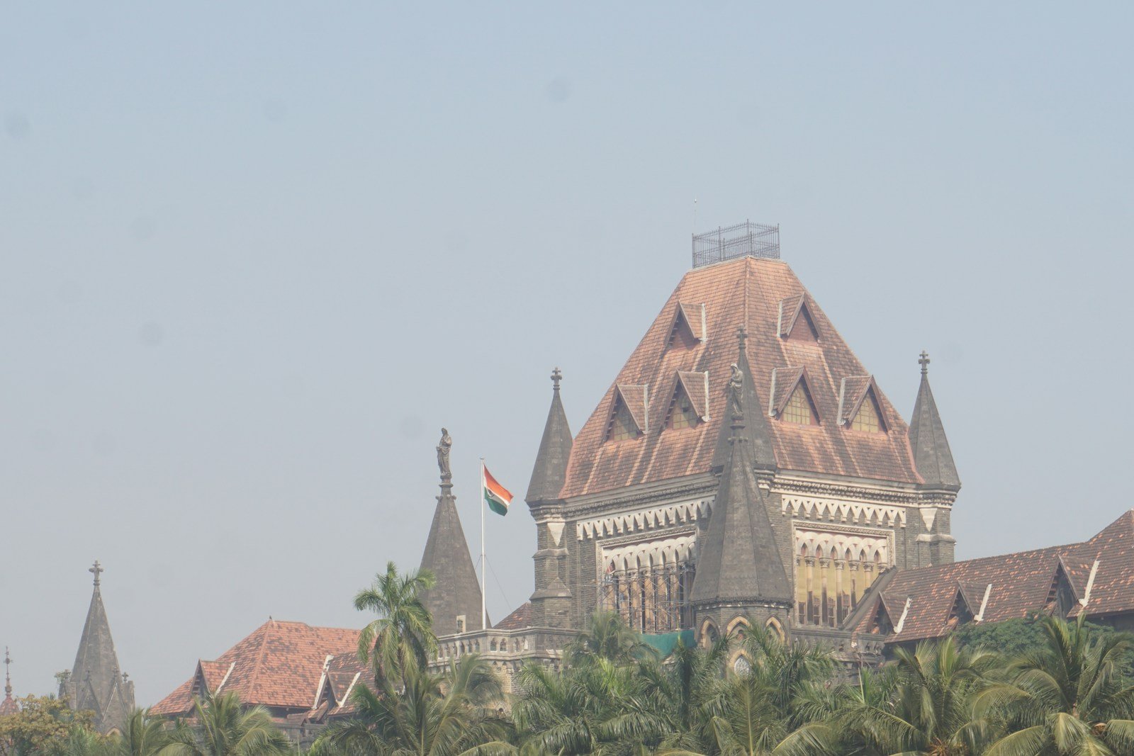 A large building with a tower and a flag on top of it