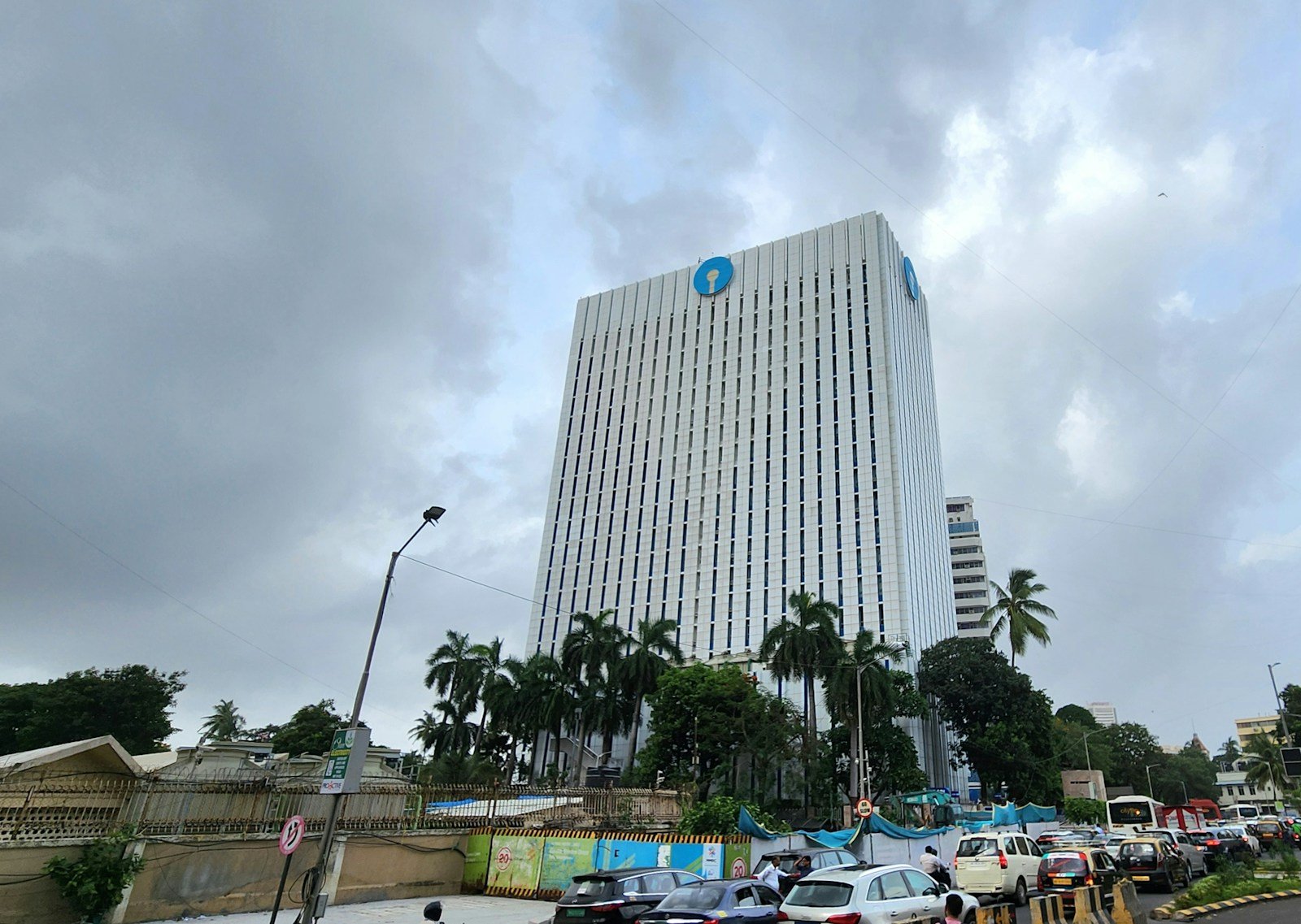 The sbi building stands tall under a cloudy sky.