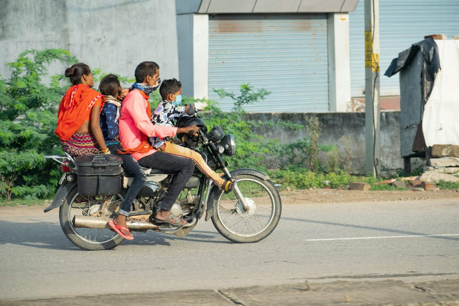a group of people ride on a motorcycle
