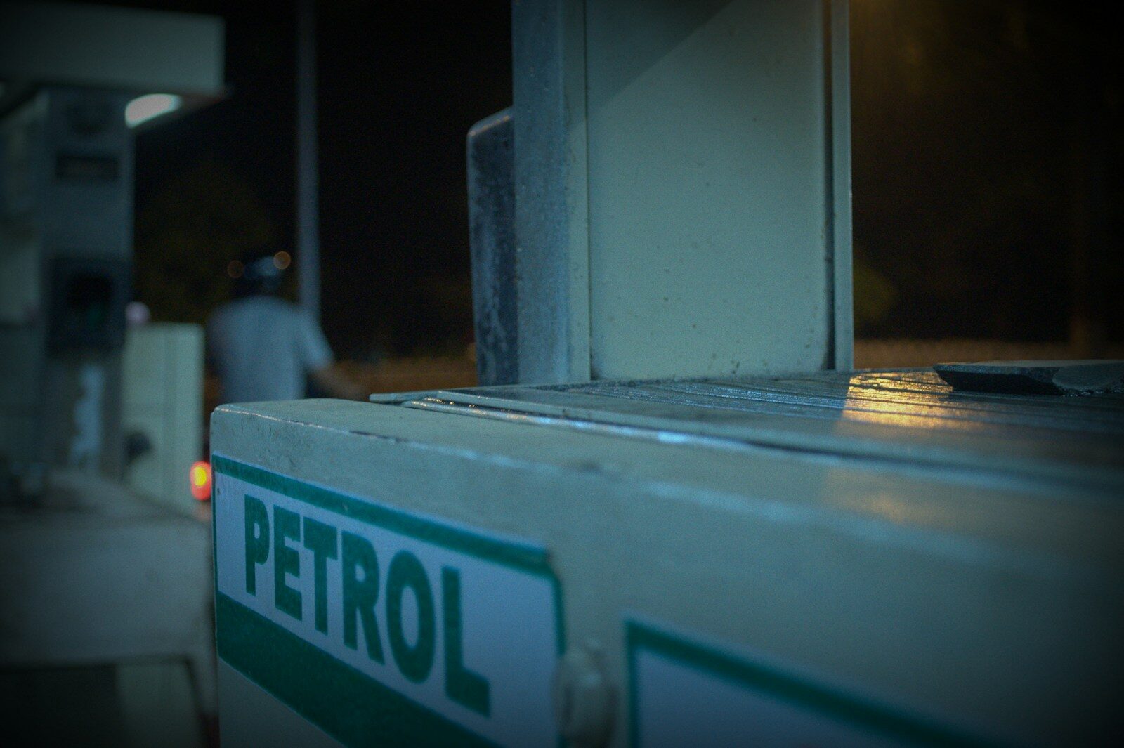 A close up of a window with a person in the background