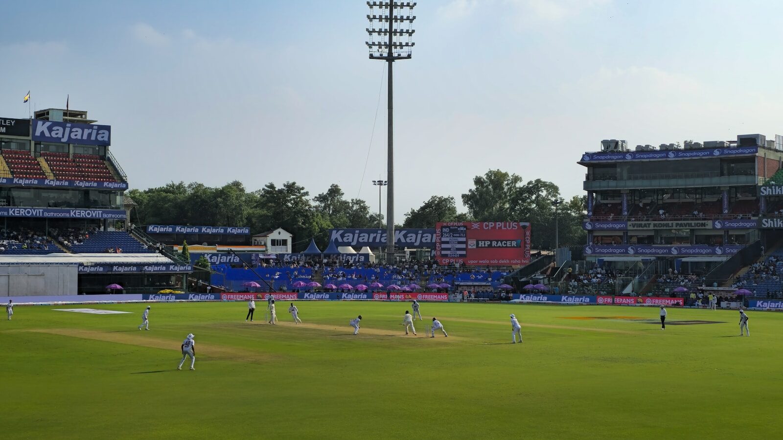 Cricket match in progress on a sunny day