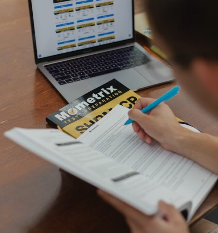 person writing on white paper